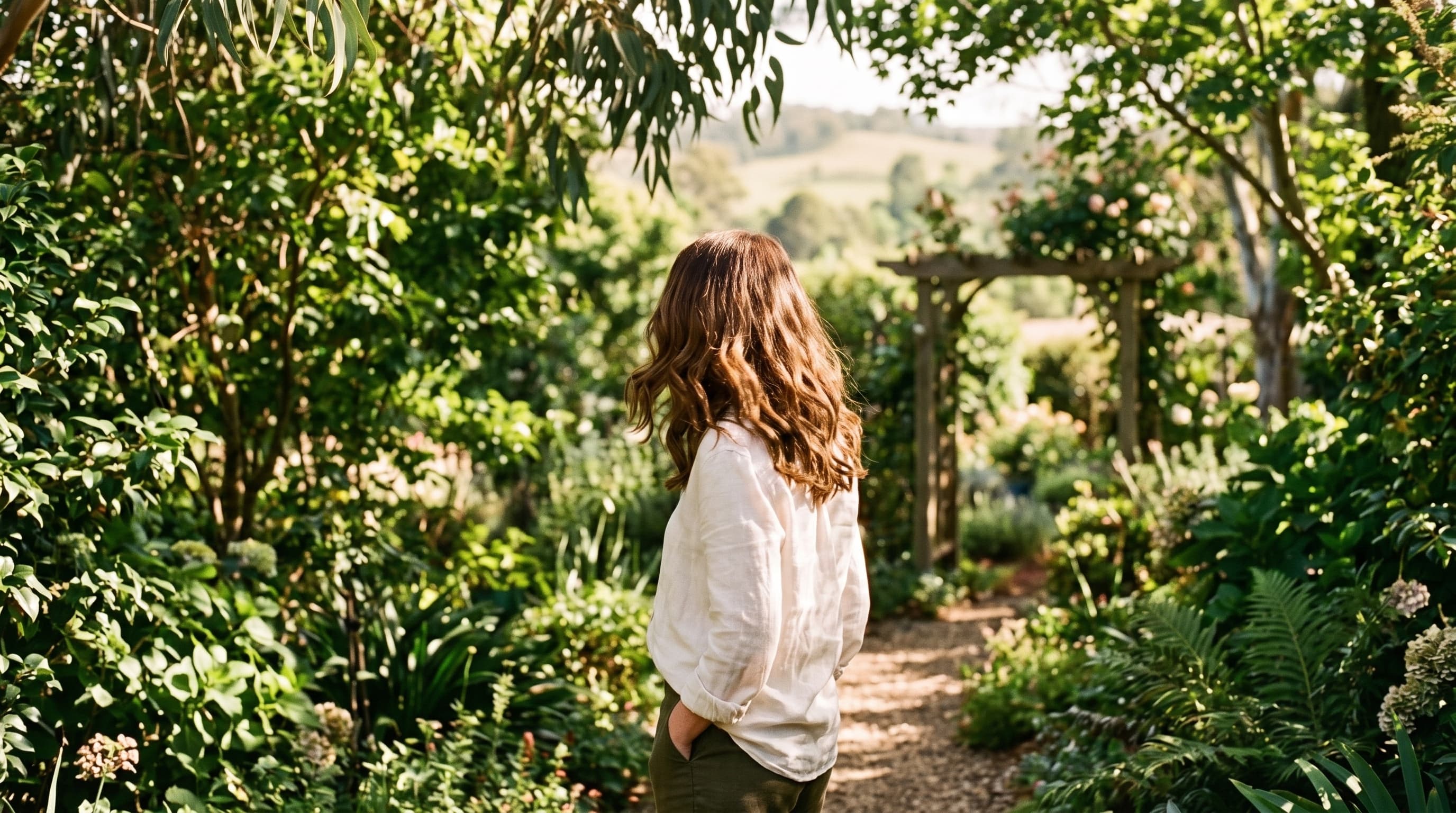 Woman with healthy hair standing in a Toowoomba garden across the seasons.