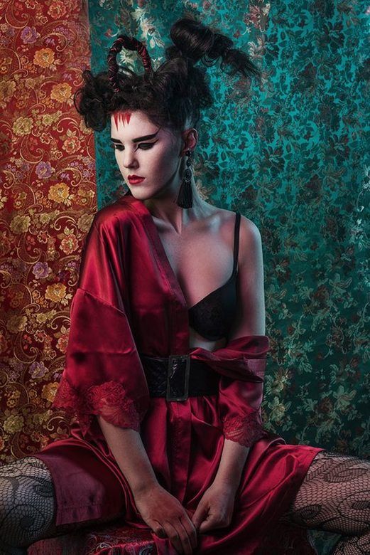 A woman with Ancient Japanese inspired make-up, seated