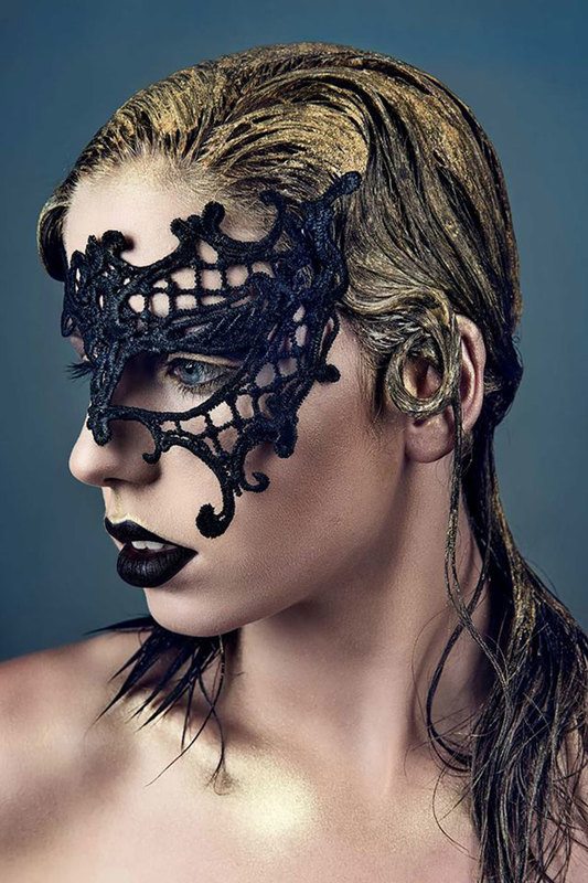 A woman wearing a mask, side view