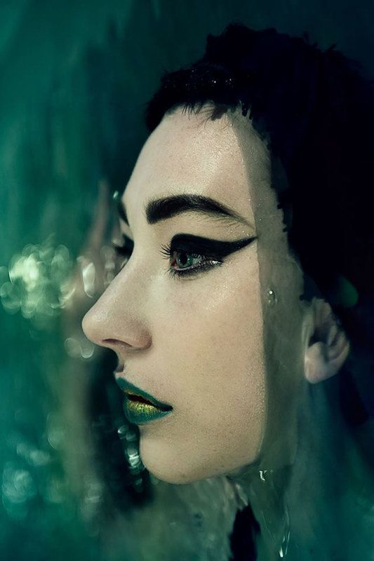 A close up shot of a woman with her head dipped in the water