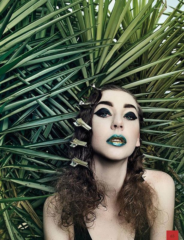 A woman in a grass background, posing