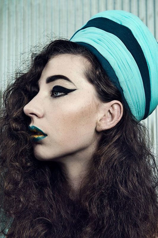 A close-up shot of a woman wearing a turquoise band, side view