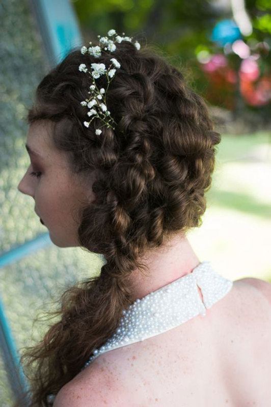 A woman facing the back flaunting her curled hair