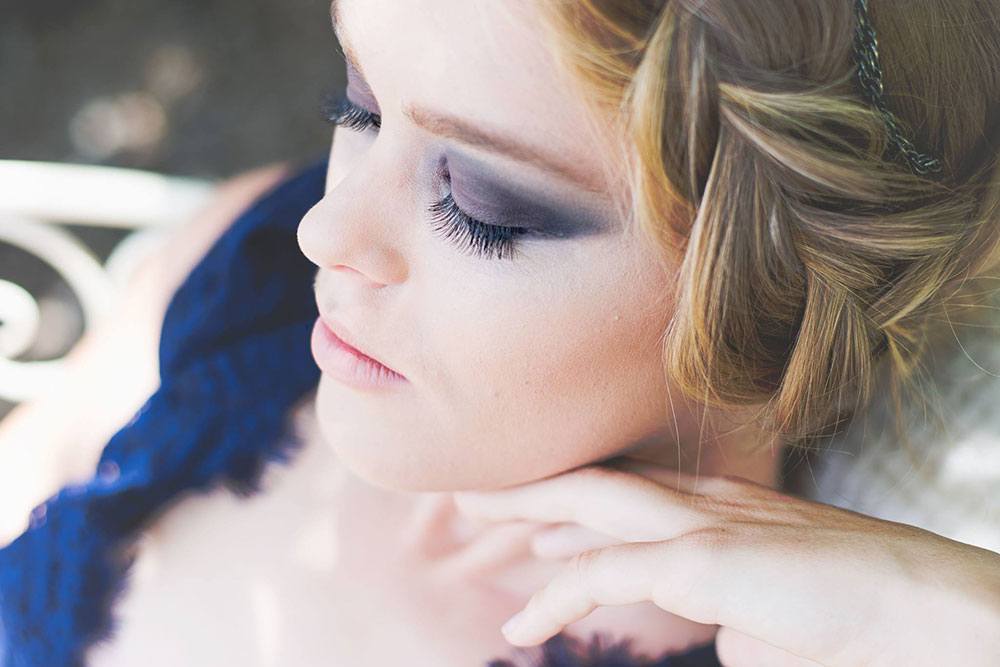 A close-up of a woman looking down, side view