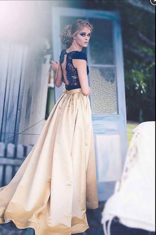 A woman standing, looking back at the camera