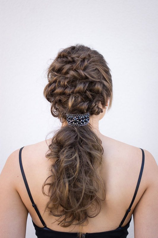 A rear shot of a woman, showing her curled hair