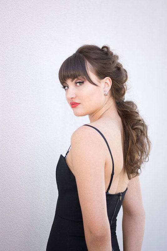 A woman looking at the camera from her side