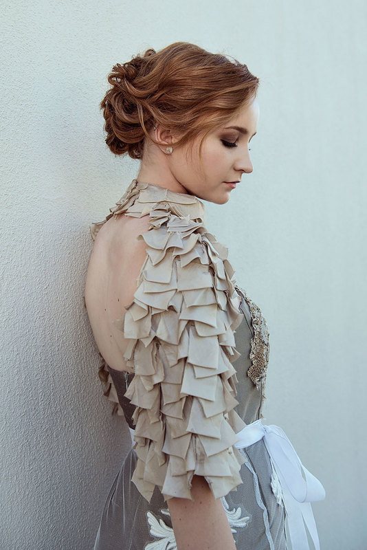 A woman with brown and grey dress facing the back