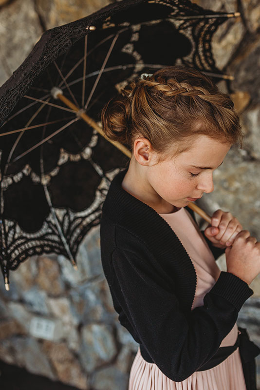 A little girl holding an umbrella