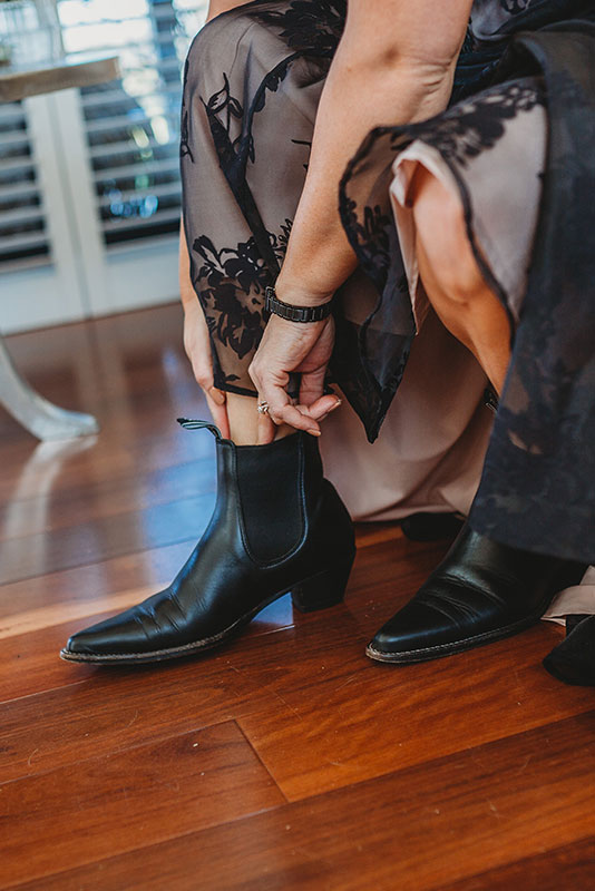 A person trying to wear a boot