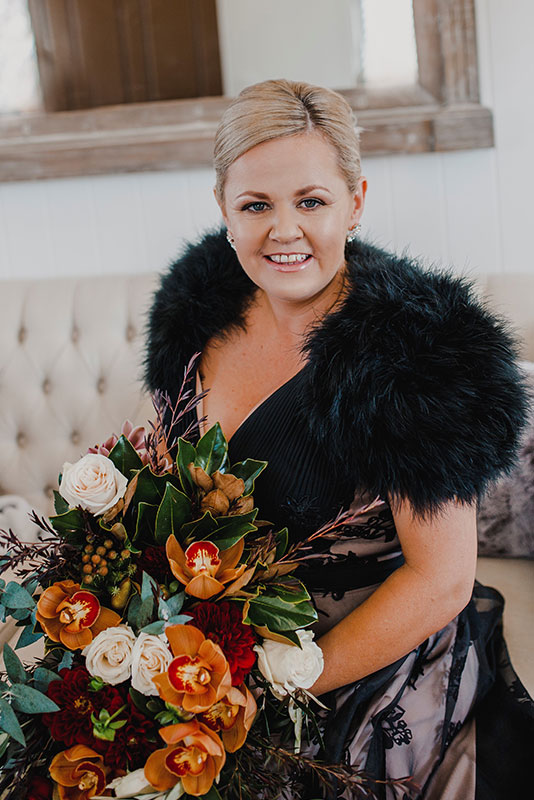 a woman holding a bouquet of flowers