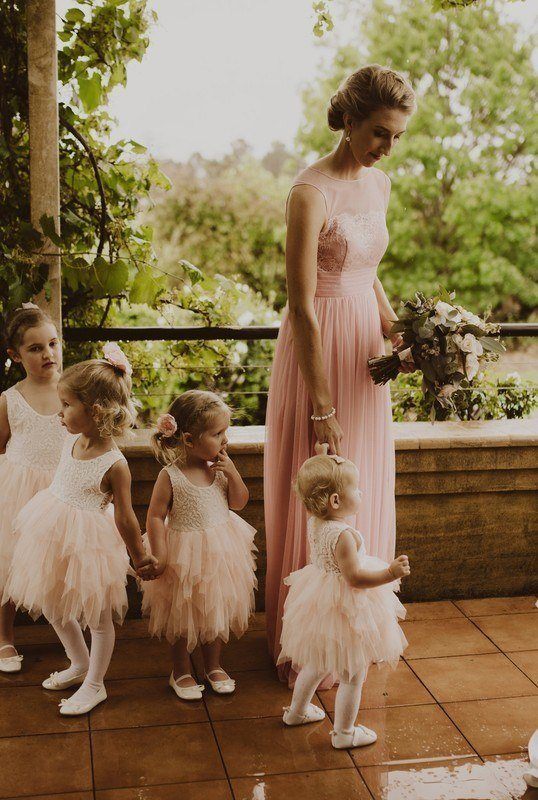 A woman in pink gown, with four little girls