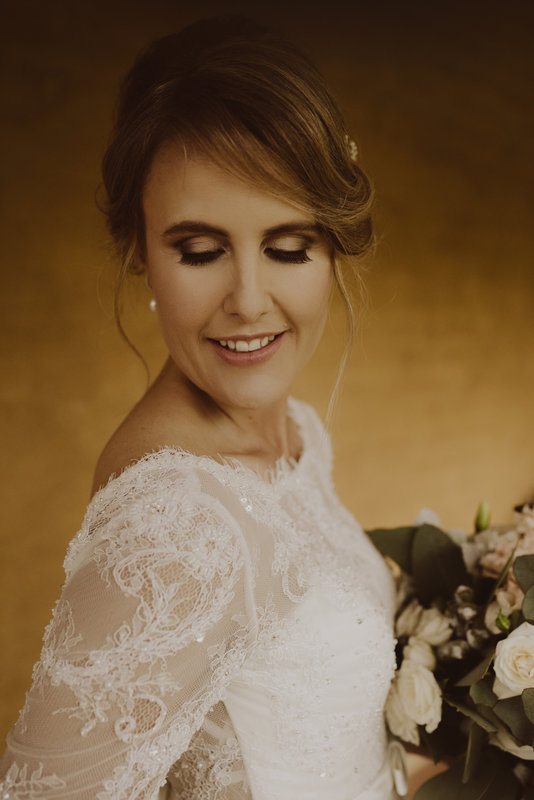 A woman in white gown, close-up, smiling