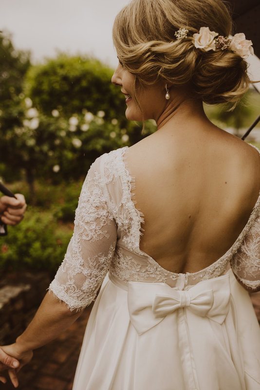 A woman in white gown, facing the back